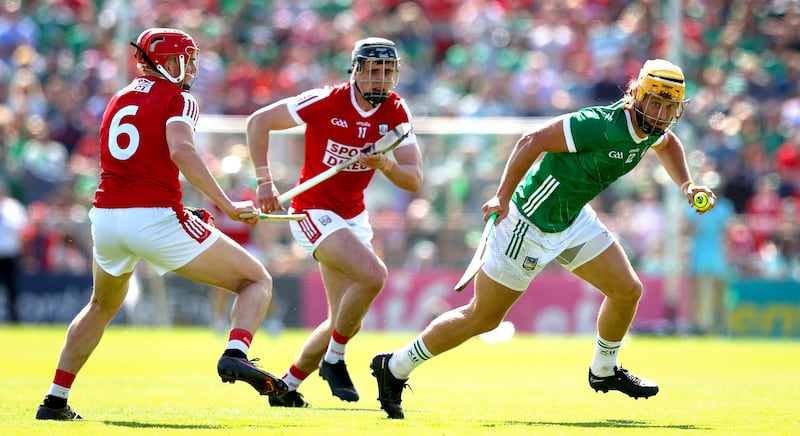 Limerick’s Tom Morrissey looks to evade the Cork defenders at the Gaelic Ground. Photograph: Ryan Byrne/Inpho