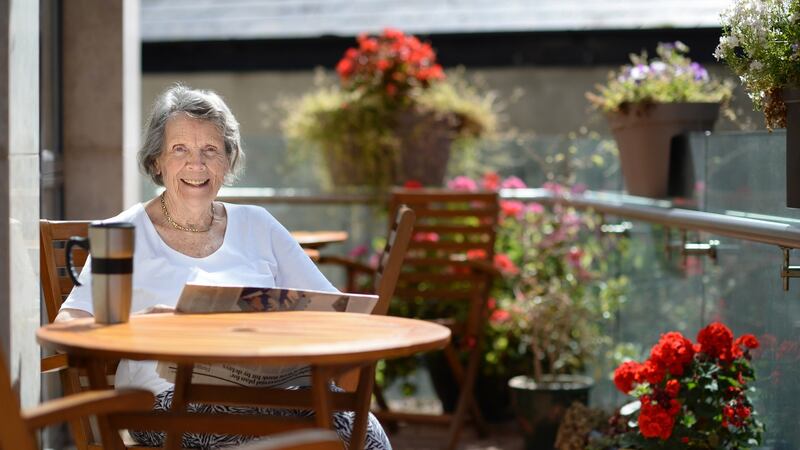 Marie-Thérèse Farrell reads the paper with a mug of coffee at Belmont House.  Photograph: Dara Mac Dónaill