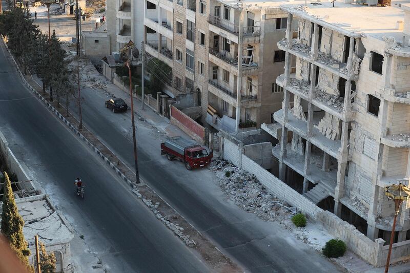 A motorcyclist drives past damaged buildings in the rebel-held northern Syrian city of Idlib on September 23rd, 2018. Photograph: Omar Haj Kadour/AFP/Getty Images