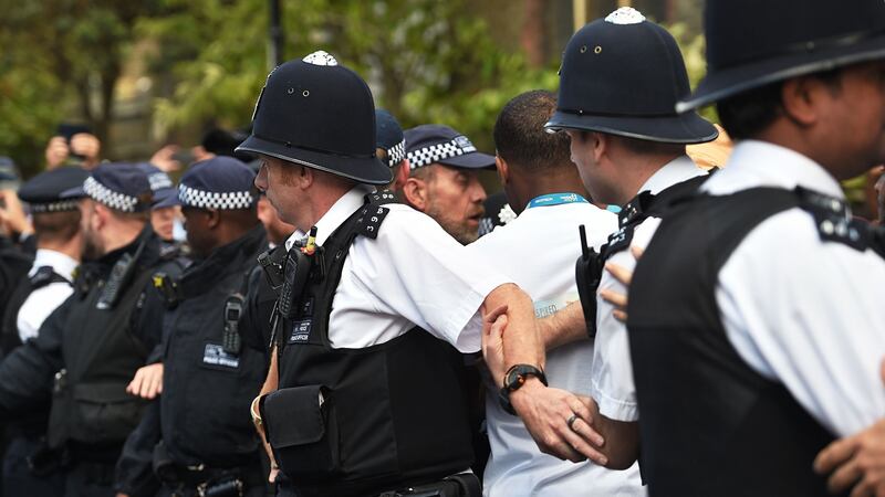 Police and crowds outside St Clement’s Church in west London, which has provided shelter and support for people affected by the fire at Grenfell Tower, during a visit from prime minister Theresa May. Photograph: David Mirzoeff/PA Wire