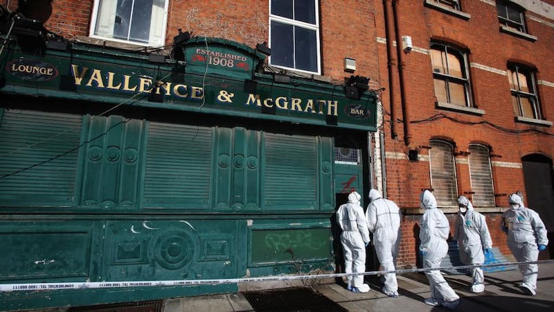 Garda forensic officers  at a disused premises on North Wall Quay where the body of a man was found shortly after 10.45pm yesterday. Photograph: PA