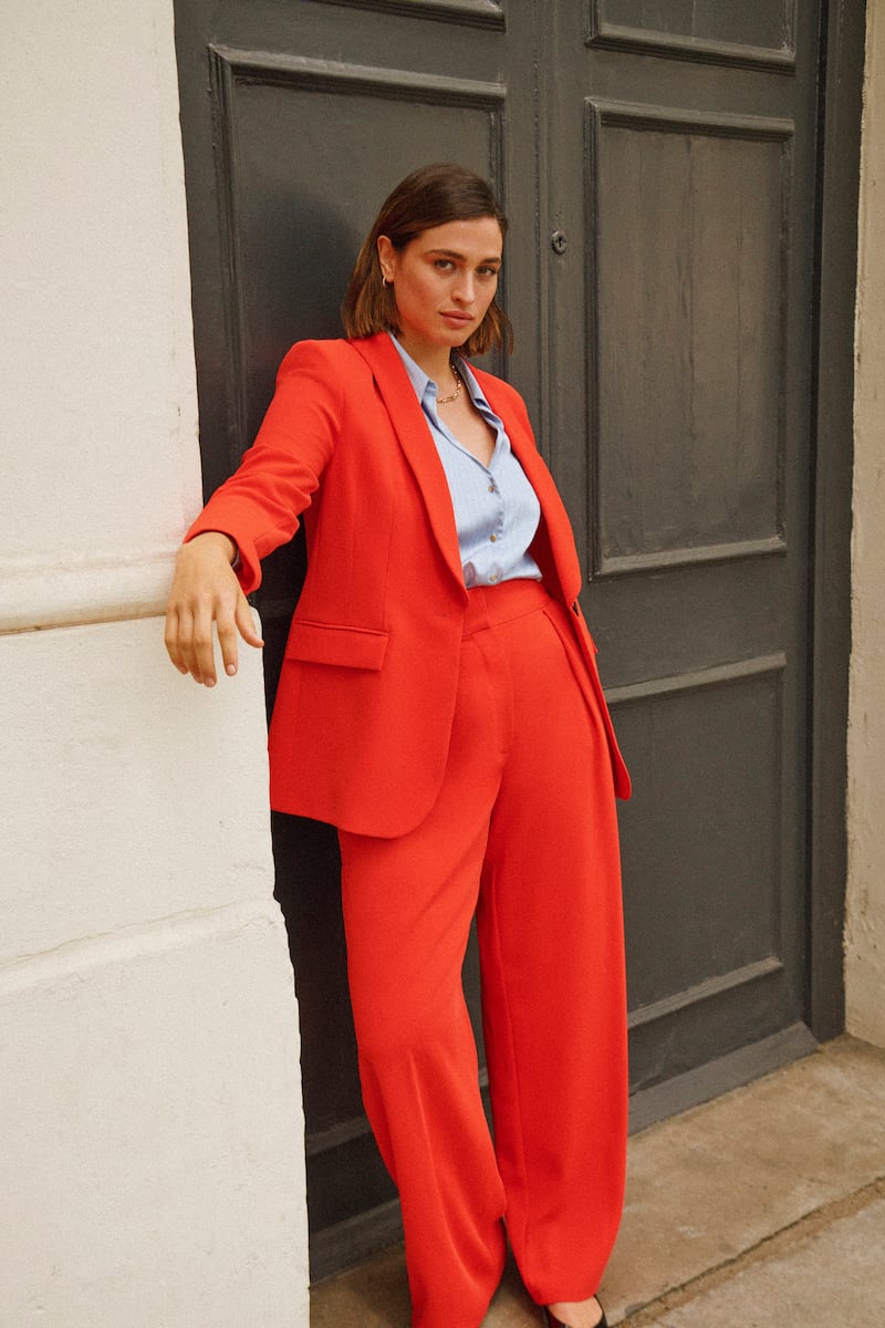 Red jacket, €100, matching trousers, €53, and blouse, €33, all from River Island