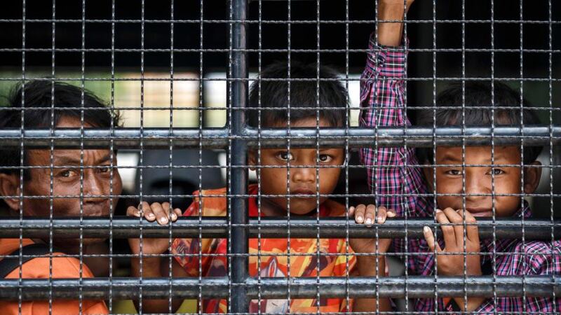 Cambodian migrants look through grills of a truck as they wait to cross the Thai-Cambodia border at Aranyaprathet in Sa Kaew today. Photograph: Athit Perawongmetha/Reuters