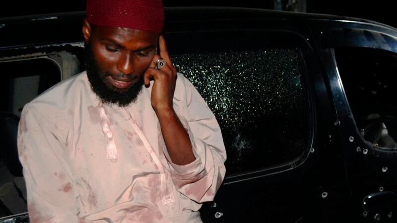 A man talks on his phone after he survived the shooting at their vehicle in which Sheikh Ibrahim Ismael and three others were killed near Kenya’s coastal city of Mombasa, today. Photograph: Charles Makunda/Reuters