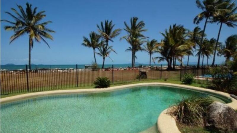 Queensland in Australia: a three-bedroom house with verandah looking out over a swimming pool  to the ocean