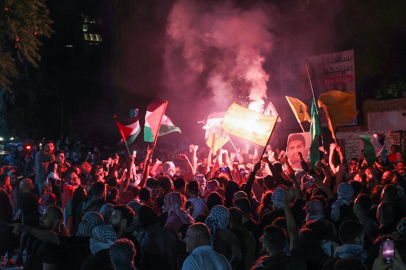 Protesters wave Palestinian flags during a rally at the entrance of the French embassy complex in Beirut early on October 18th, 2023, in support of Palestinians after a blast ripped through the Ahli Arab hospital. Photograph: ANWAR AMRO/AFP via Getty Images