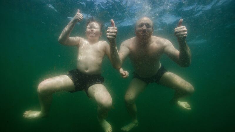 Derek Halpin with his son Ewan Halpin at the Forty Foot in Dublin after the country entered phase one of re-opening on May 18th. Photo: Bryan Keane/Inpho