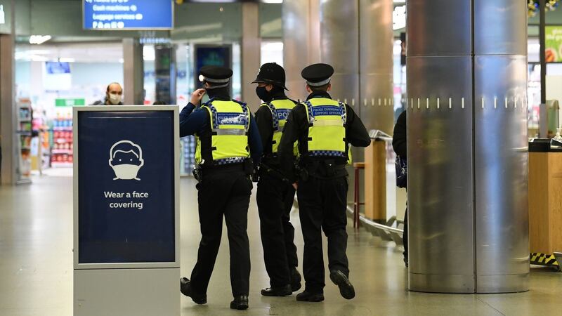 Police officers have been deployed to some train stations - including at St Pancras above -  to enforce new travel restrictions.