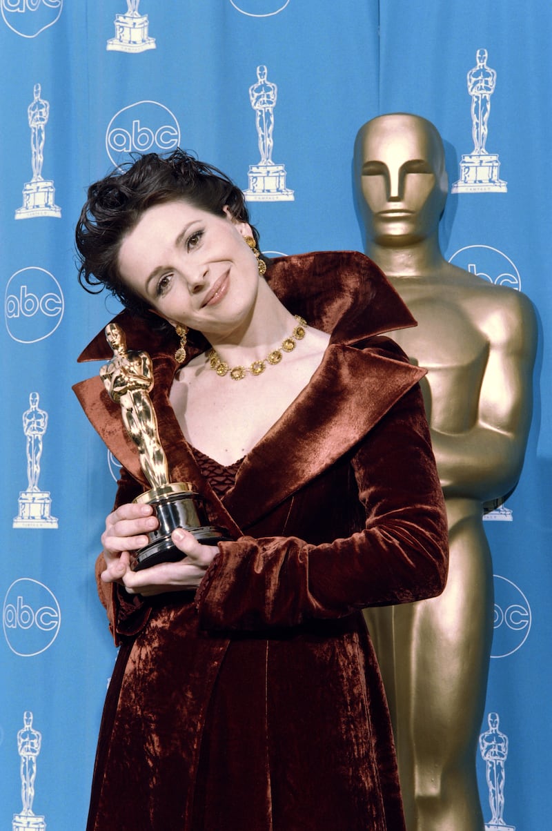 Juliette Binoche smiles as she holds her Oscar for best supporting actress in The English Patient, March 1997. Photograph: Kim Kulish/AFP via Getty Images