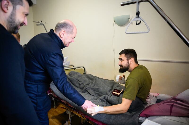 German chancellor Olaf Scholz (centre) and Ukrainian president Volodymyr Zelenskiy visit a wounded soldier in a hospital in Kyiv. Photograph: Marvin Ibo Güngör/Bundesregierung/Getty