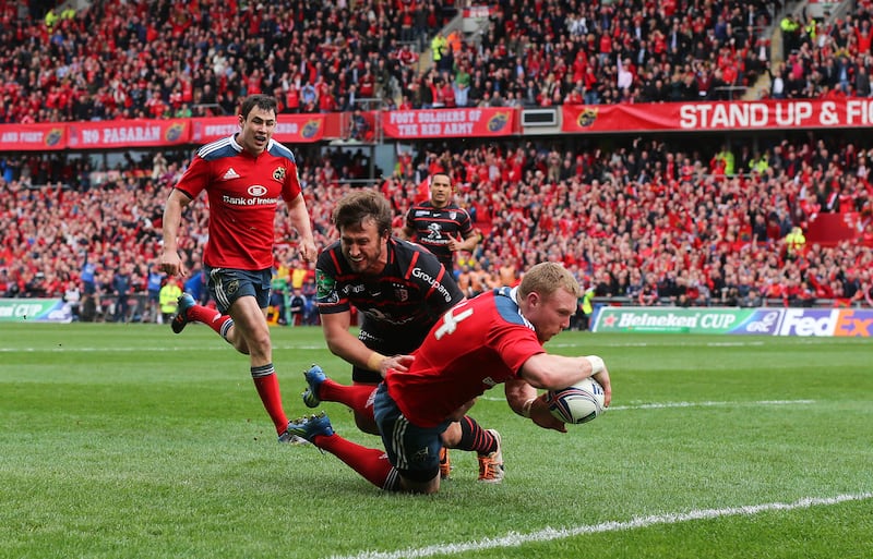 Munster's Keith Earls scores a try against Toulouse despite the efforts of  Maxime Medard in the 2014 Heineken Cup quarter-final at Thomond Park. Photograph: Cathal Noonan/Inpho 