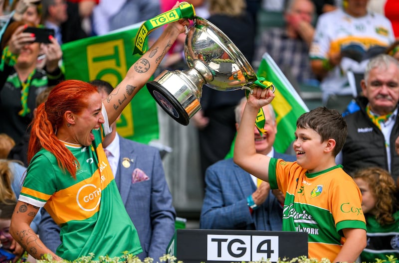 Charlene Tyrrell of Leitrim and her son Noah lift the Mary Quinn Memorial cup after the TG4 All-Ireland intermediate final win over Tyrone at Croke Park. Photograph: Ray McManus/Sportsfile 