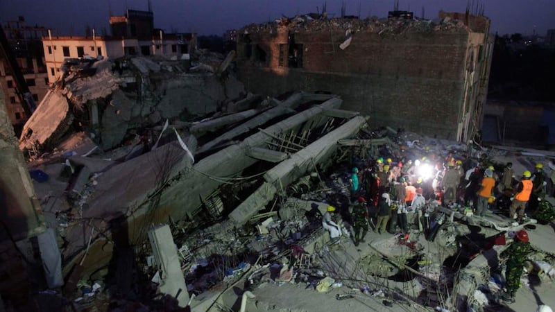 Rescue workers attempt to rescue garment workers from the rubble of the collapsed Rana Plaza building. Photograph: Andrew Biraj/Reuters