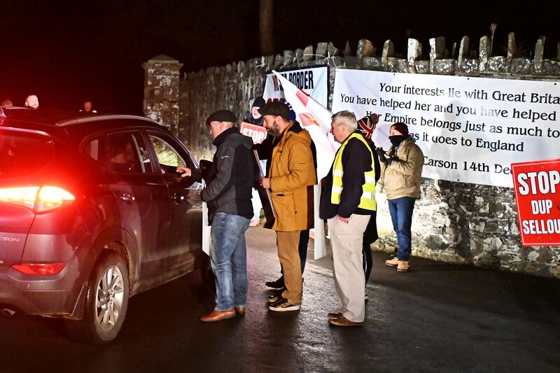 Unionist protestors demonstrate against a possible DUP decision to accept the government offer to go back into the Stormont assembly outside Larchfield House on Monday night in Lisburn, Northern Ireland. Photograph: Charles McQuillan/Getty