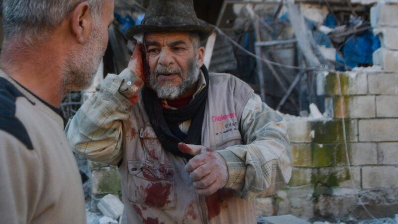 An injured man waits to be transported for treatment following an air strike by pro-Syrian regime forces in Maarrat Misrin in Idlib. Photograph: Mohammed Al-Rifai/AFP