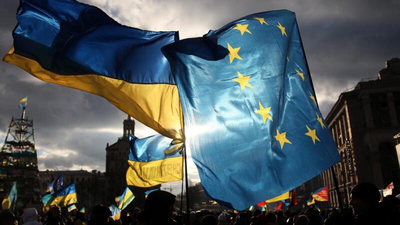 Two men hold EU and Ukrainian flags during the pro-European  rally at Independent Square in Kiev on Thursday. Photograph: Zurab Kurtsikidze/EPA