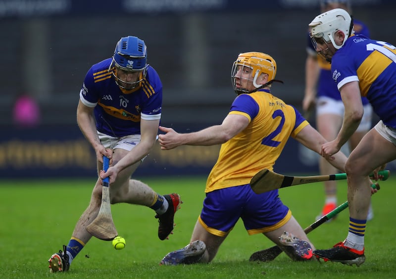 Na Fianna's Sean Burke in action with Mark Hennessy of Clough Ballacolla. Photograph: Leah Scholes/Inpho