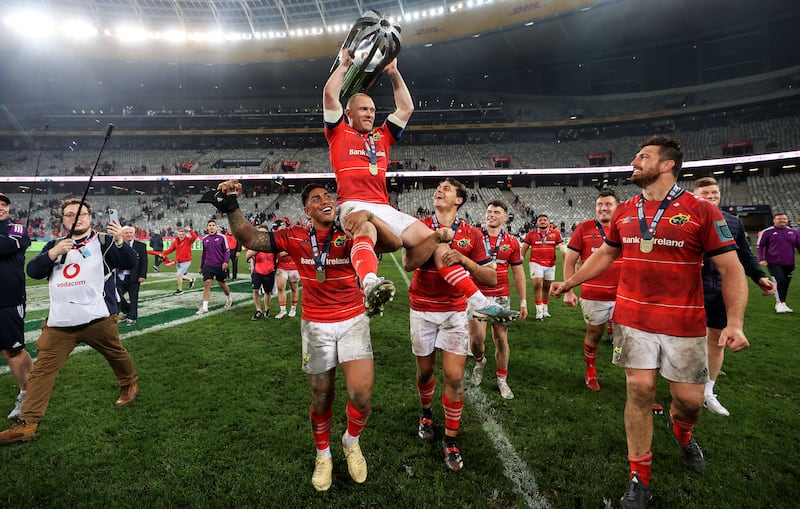 Keith Earls holds the trophy as he is hoisted on the shoulders of Malakai Fekitoa and Antoine Frisch after the URC Final win over the Stormers at  DHL Stadium in Cape Town. Photograph: James Crombie/Inpho