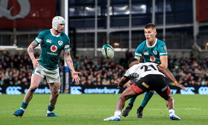 Pendergast plays a pass to Mack Hansen as he's tackled by Fiji's Pani Matawalu. Photograph: Dan Sheridan/Inpho