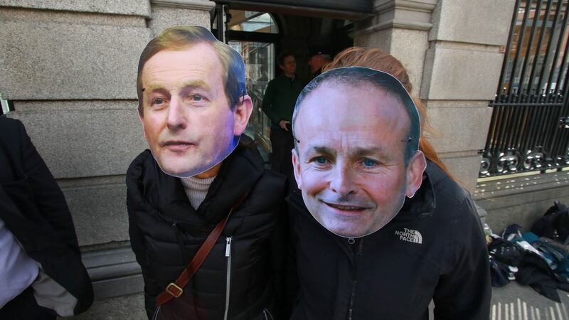 Face-off: participants in the Robinhoodtax.ie protest wear Enda Kenny and Micheál Martin masks outside the Dáil. Photograph: Nick Bradshaw