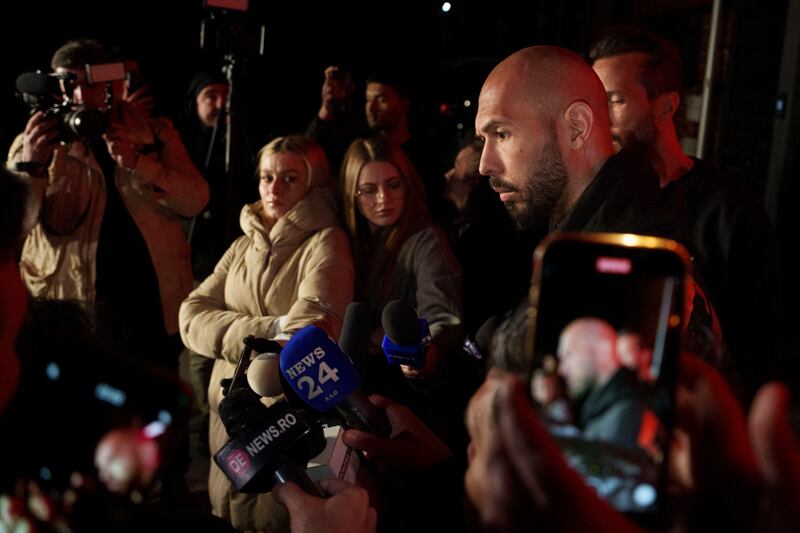 Andrew Tate, left, speaks to the media next to his brother Tristan, after returning from the United States (AP/Andreea Alexandru)