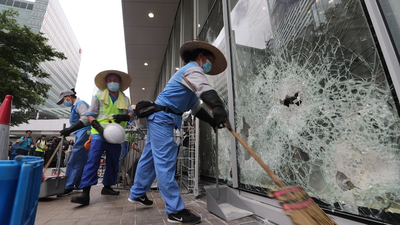 Cleaners clear remaining items and broken glass around the Legislative Council Building on Tuesday. Photograph: Ritchie B Tongo/EPA