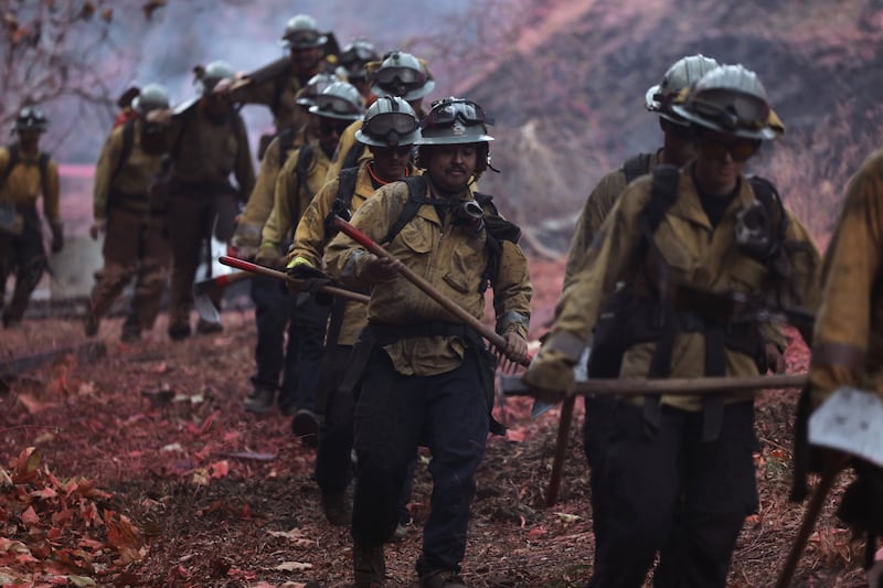 Firefighters hike into the Palisades wildfire in Los Angeles. Photograph: EPA