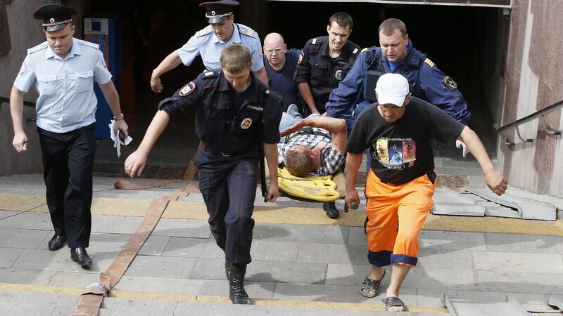 An injured passanger is carried to an ambulance from the ‘Park Pobedy’ metro station. Photograph: Yuri Kochetkov