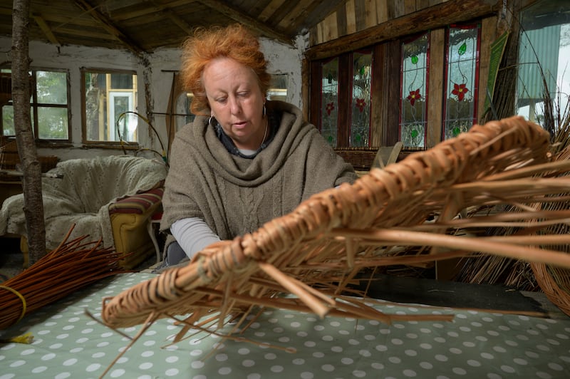 Kate Burrows in her Westcountry Willows workshop weaving the lid of a basket coffin. Photograph: Michael McLaughlin