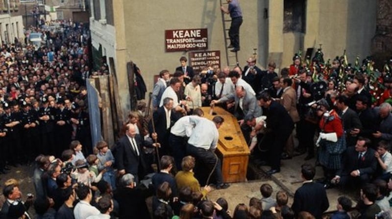 Crowds gathered outside Keane’s lorry depot in Kilburn to watch the coffin being lowered into the ground. Photograph: Killorglin Archive Society