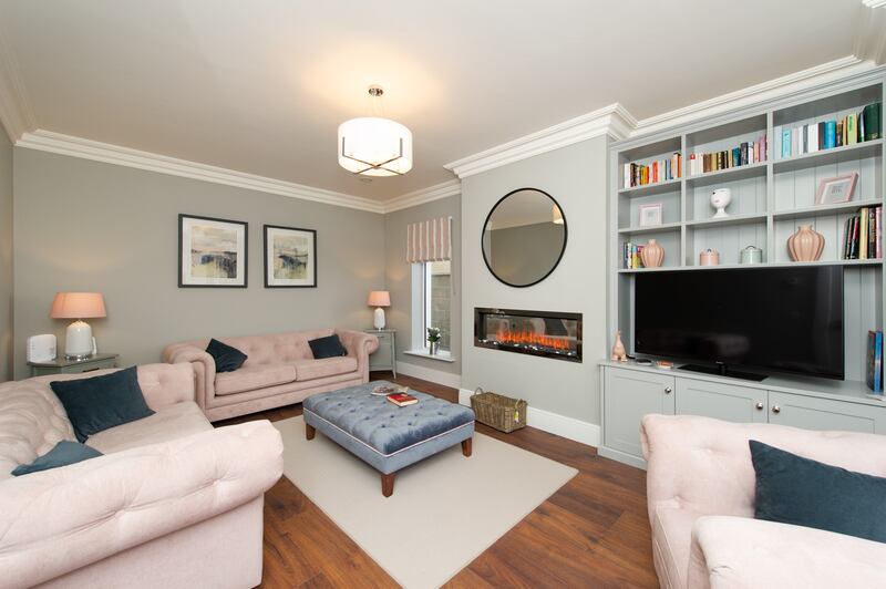 A living room in a four-bedroom unit