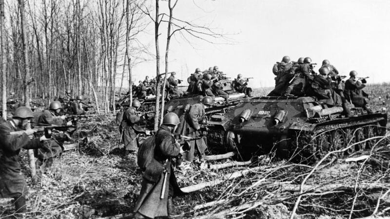 Military history: Soviet infantry use Malyshev T34 tanks for cover as they attack German positions in the second World War. Photograph: Sovfoto/UIG via Getty