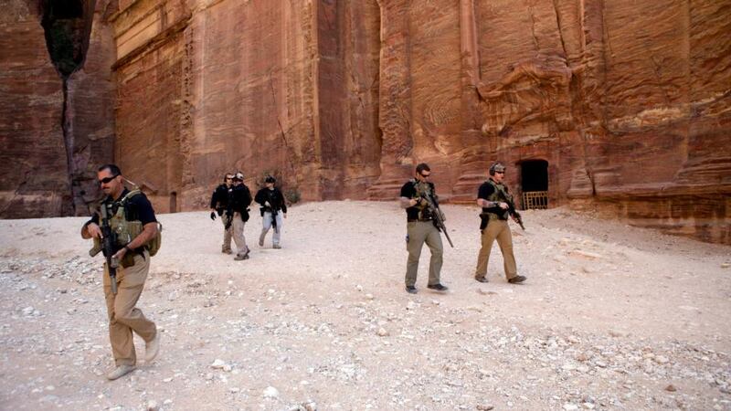 Secret Service agents walk ahead of US president Barack Obama as he takes part in a walking tour of the ancient city of Petra, Jordan. Photograph: Doug Mills/The New York Times