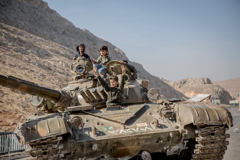 Children play on a tank following the fall of the Assad regime in Syria. Photograph: Sally Hayden