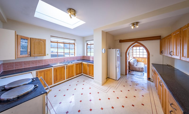 Inside the front hallway lie a kitchen and a diningroom on one side.