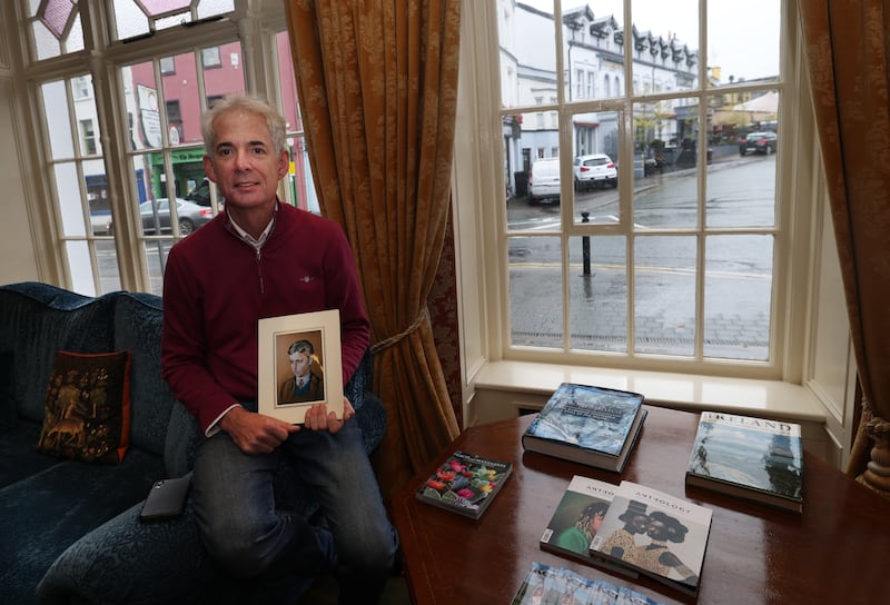 Sean Buckley, proprietor of the Arbutus Hotel in Killarney, holds a  copy of the portrait of his father Pat, painted by Harry Kernoff in 1943. Photograph: Bryan O’Brien