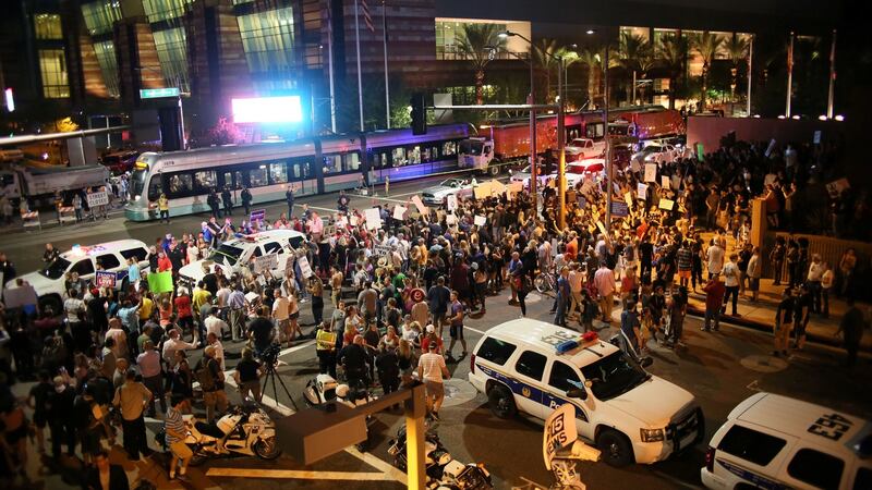 Pro-Trump supporters face off with peace activists during protests outside a Donald Trump campaign rally in Phoenix, Arizona. Photograph: Sandy Huffaker/EPA