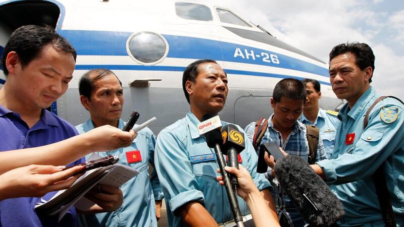 Vietnamese pilot Vu Duc Long (c) answers questions about search and rescue operations for a missing Malaysian Airlines flight after landing at Tan Son Nhat international airport, Ho Chi Minh, Vietnam. Photograph: Luong Thai Linh/EPA