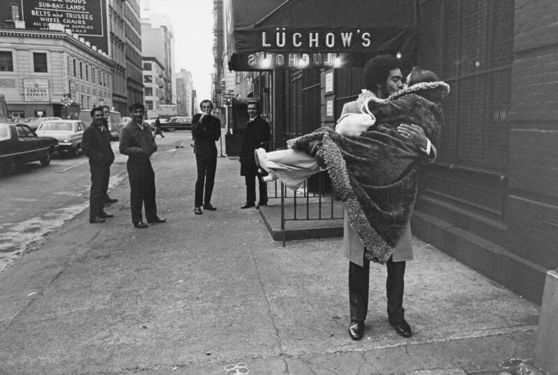 A newly married couple share a kiss outside Luchow's restaurant on East 14th Street, New York City, 1970. Jill Freedman/ Courtesy the Jill Freedman Foundation