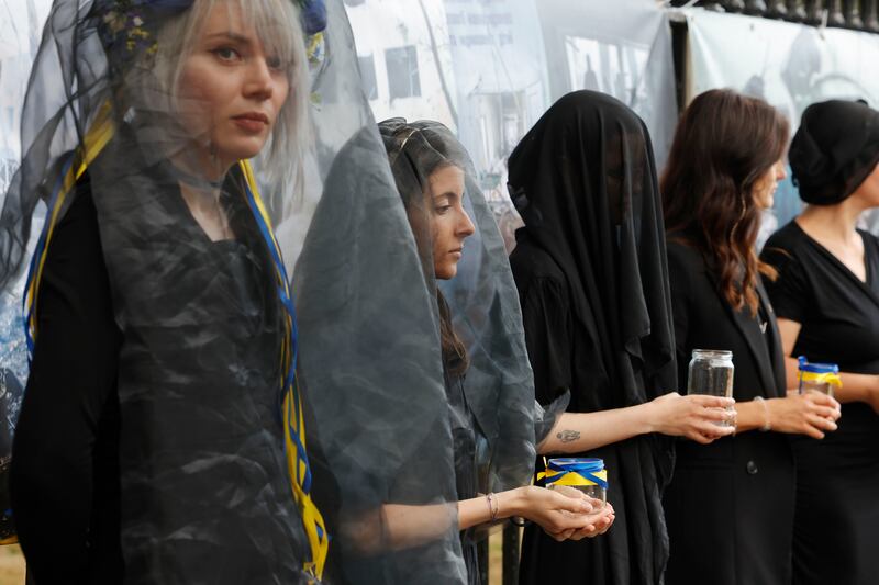 Members of Ukrainian Action Ireland take part in The Silenced Widows protest, a global action honouring Ukrainian widows and their fallen soldiers near  St Patrick’s Cathedral, in Dublin on Saturday.