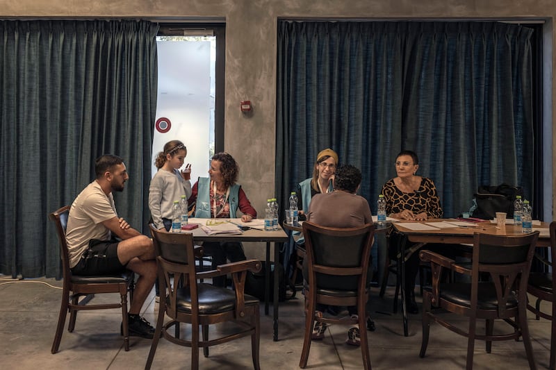 Residents of Kfar Aza learn more about the assistance they can receive as victims of  the Hamas attack during a meeting in Shefayim, Israel, where they are temporarily living, earlier this month.  Photograph: Avishag Shar-Yashuv/New York Times
                      