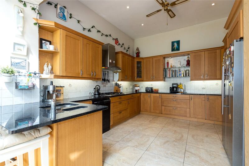 The kitchen is at the back of the house in an extension and has an island with seating