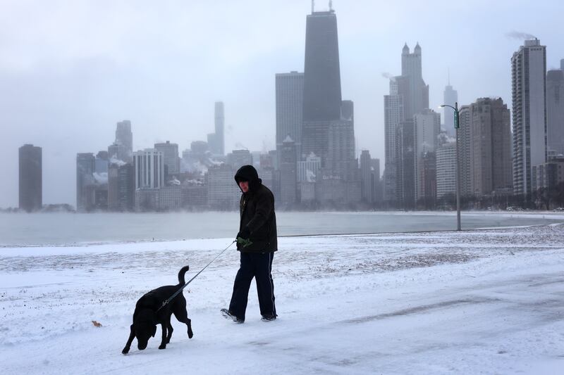 A man walks his dog along the lakefront near downtown Chicago in temperatures of minus 6 degrees on December 22nd. Photograph: Scott Olson/Getty Images