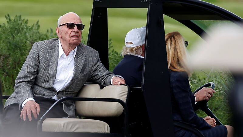 Rupert Murdoch, Donald Trump and Jerry Hall at Trump International Golf Links in Aberdeen, Scotland.  Photograph: Carlo Allegri