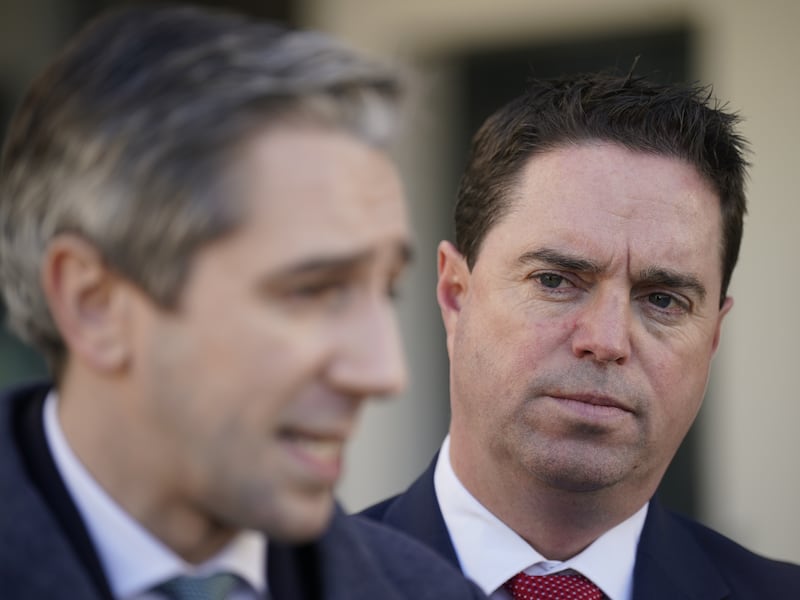 Martin Heydon listens on as Taoiseach Simon Harrie speak to the media. Photograph: Niall Carson/PA Wire