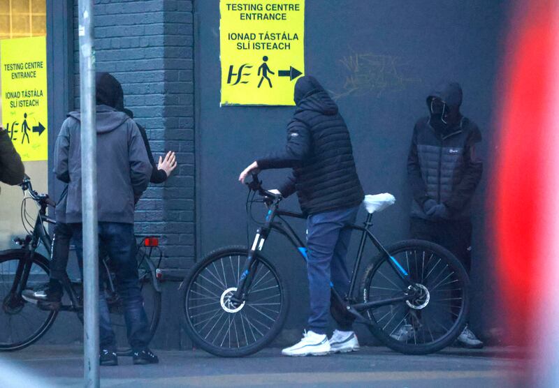 Masked and hooded individuals on Aston Quay in Dublin. Photograph: Alan Betson / The Irish Times

