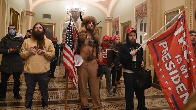 Member of the QAnon conspiracy group Jake Angeli, aka Yellowstone Wolf, enters the US Capitol with other demonstrators. Photograph: Saul Loeb/AFP via Getty