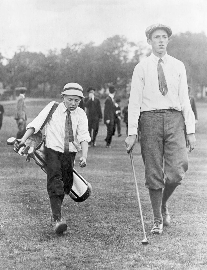 Francis Quimet and his caddy, Eddie Lowery, play golf at Brookline in 1913. Photograph: George Rinhart/Corbis via Getty