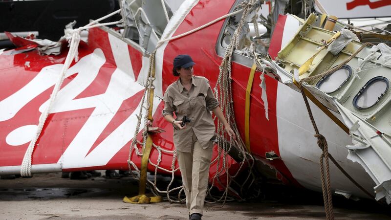 An Airbus investigator walks near part of the tail of the AirAsia  passenger plane in Kumai Port, near Pangkalan Bun, Central Kalimantan in  January 2015. Photograph: Reuters