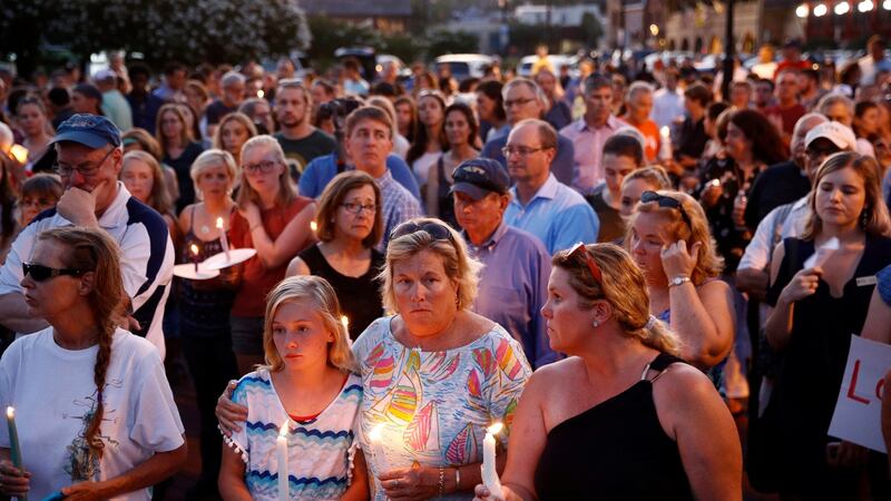 Mourners stand in silence during a vigil in response to a shooting at the Capital Gazette newsroom on Friday in Annapolis. Photograph: Patrick Semansky/AP